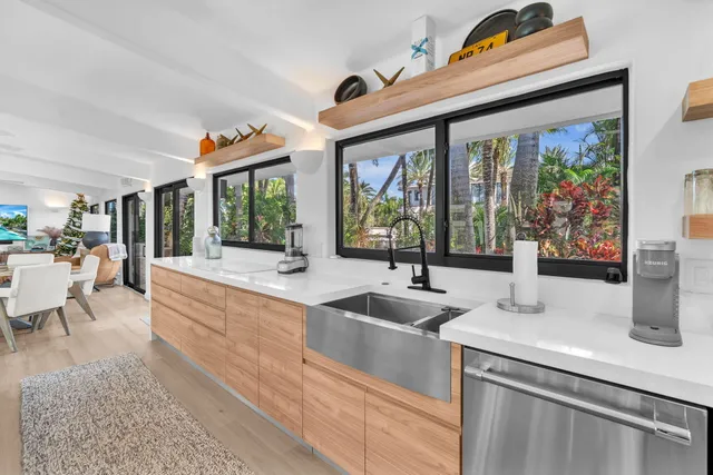 a dining room with furniture and a large window