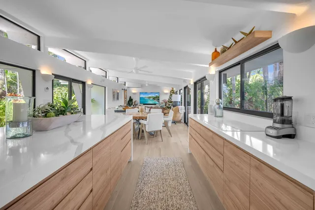 a spacious bedroom with a bed and large windows