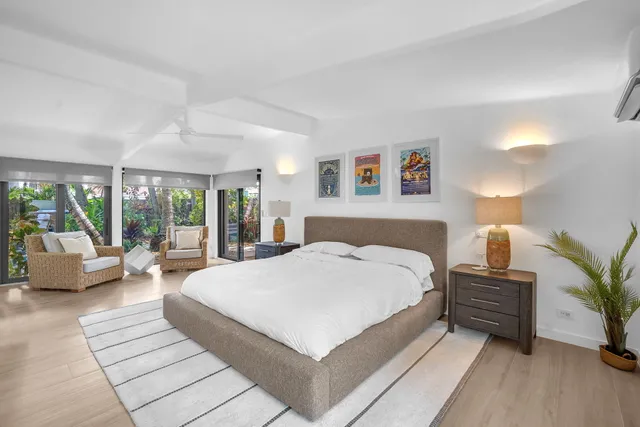 a large bedroom with a bed and a dresser