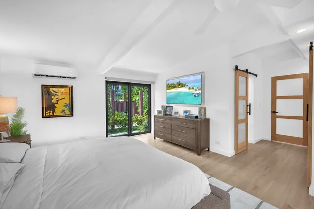 a bedroom with a bed and a large window with outer view