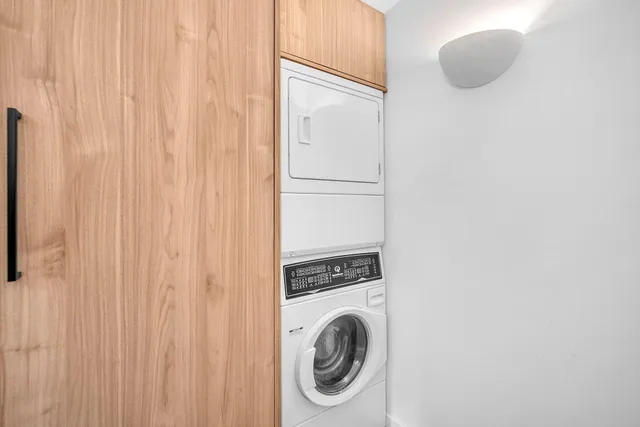 a view of a yard with plants and large trees