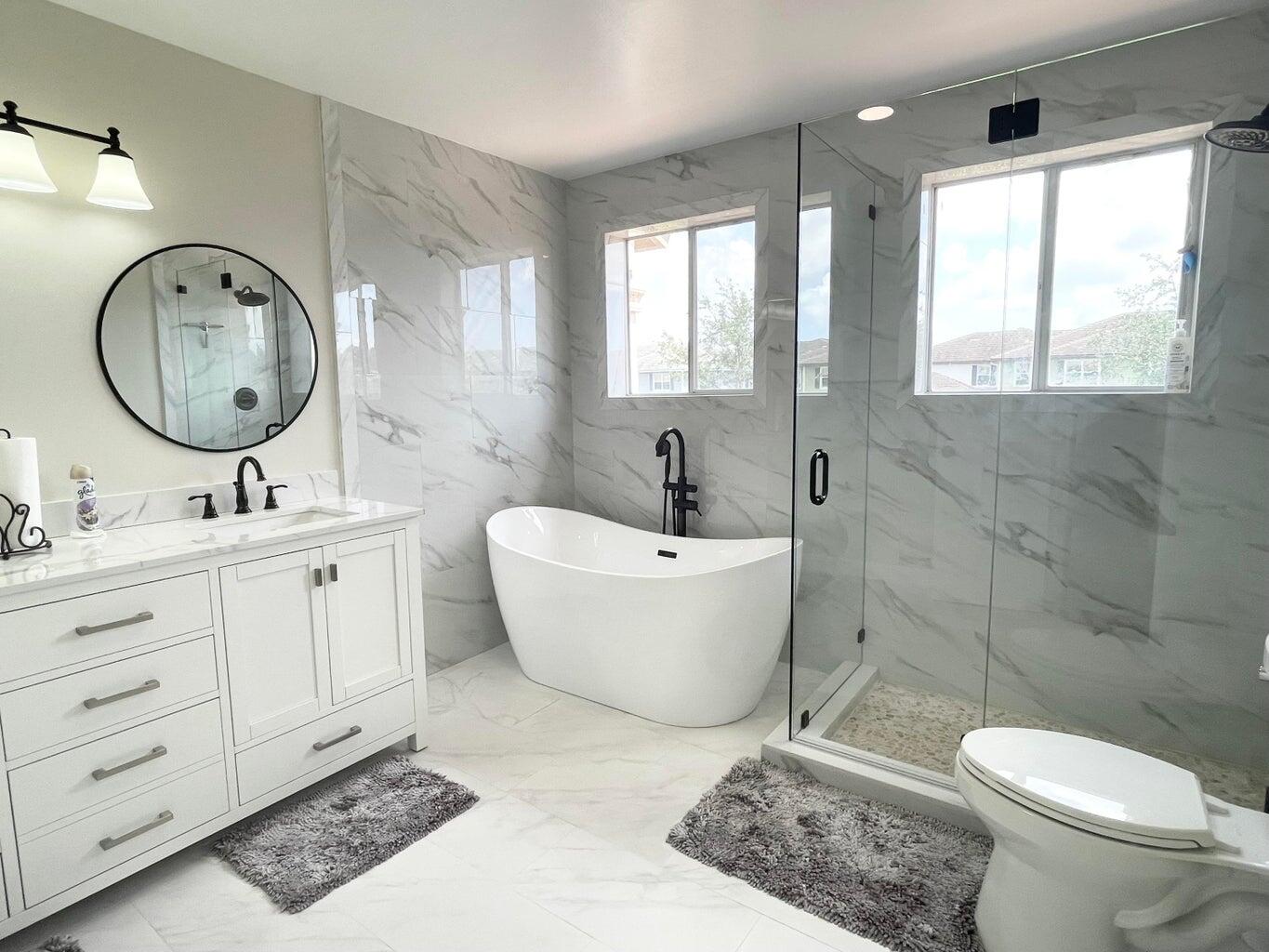 a bath room with a toilet a sink and a mirror