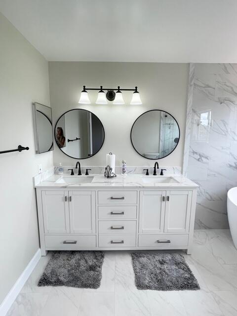 6763 Via Regina Boca Raton, FL 33433 - Photo 11 of 39 a bathroom with a double vanity sink and a mirror