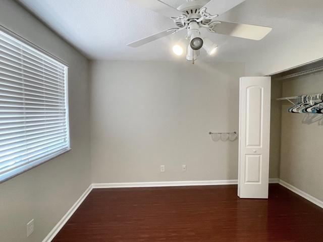 6763 Via Regina Boca Raton, FL 33433 - Photo 19 of 39 an empty room with wooden floor chandelier fan and windows