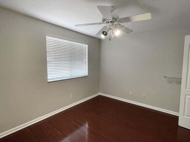 6763 Via Regina Boca Raton, FL 33433 - Photo 21 of 39 an empty room with wooden floor and windows