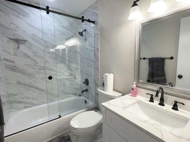 6763 Via Regina Boca Raton, FL 33433 - Photo 22 of 39 a bathroom with a sink toilet vanity and shower