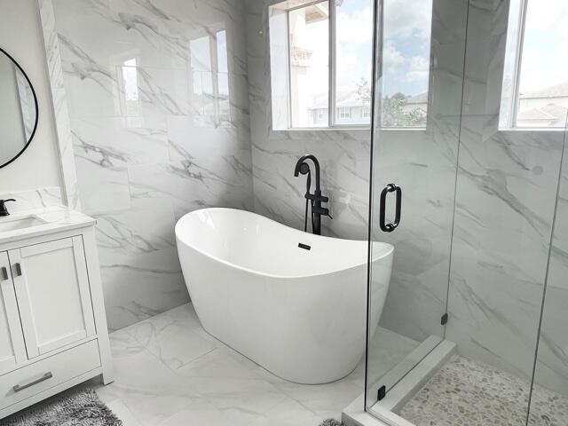 6763 Via Regina Boca Raton, FL 33433 - Photo 10 of 39 a white bath tub sitting next to a shower