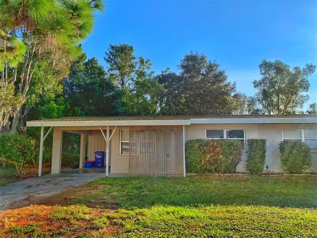 a view of a house with yard and a garden