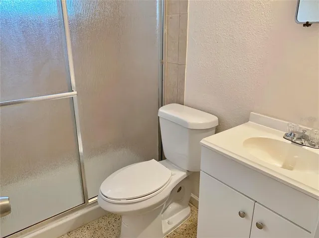 a white toilet sitting next to a bathroom sink