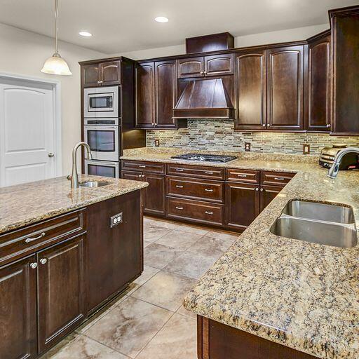28 Haven Way Freeport, FL 32439 - Photo 12 of 50 a kitchen with stainless steel appliances granite countertop wooden cabinets a refrigerator and a sink