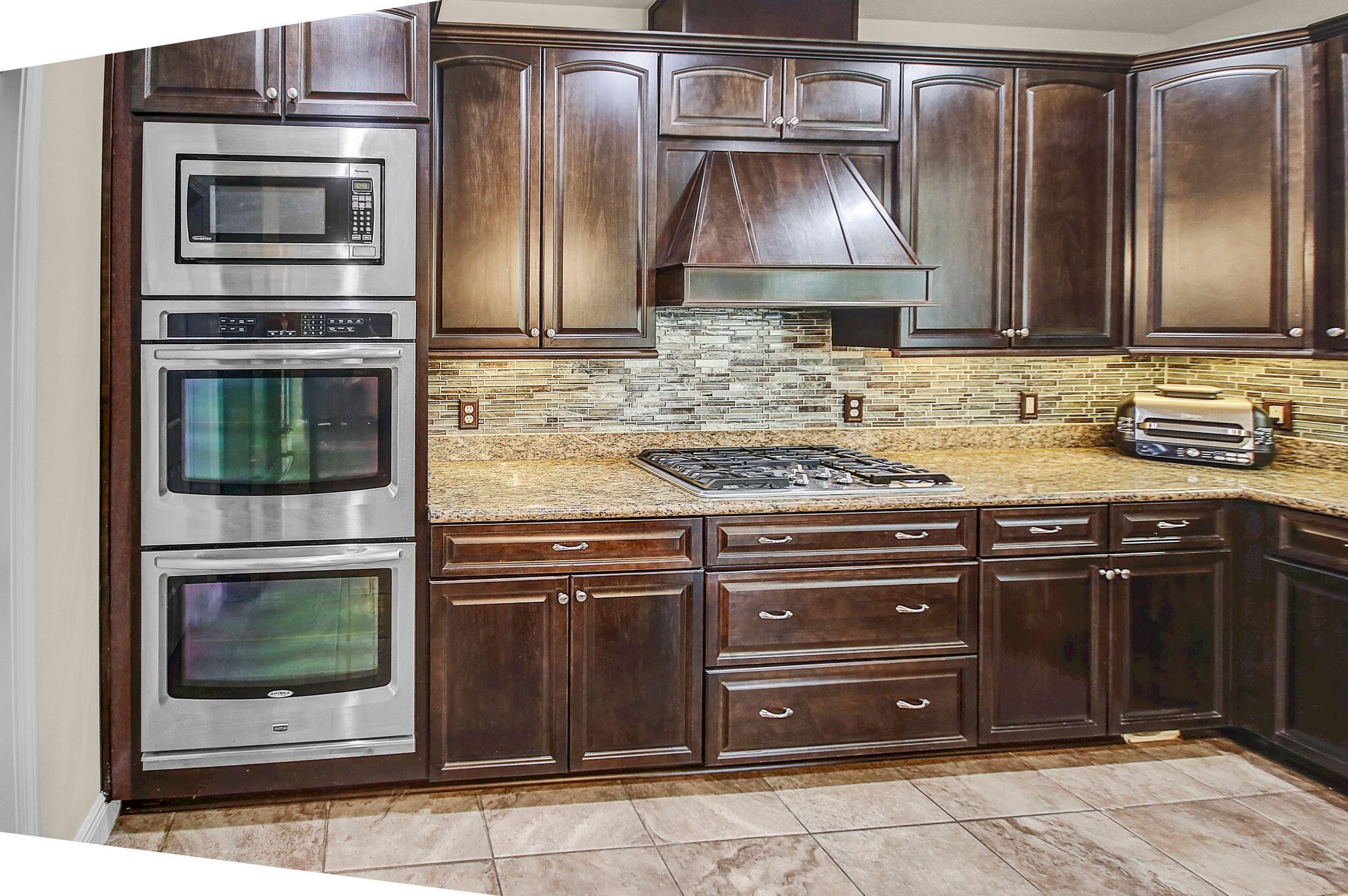 28 Haven Way Freeport, FL 32439 - Photo 13 of 50 a kitchen with stainless steel appliances granite countertop a stove microwave and refrigerator