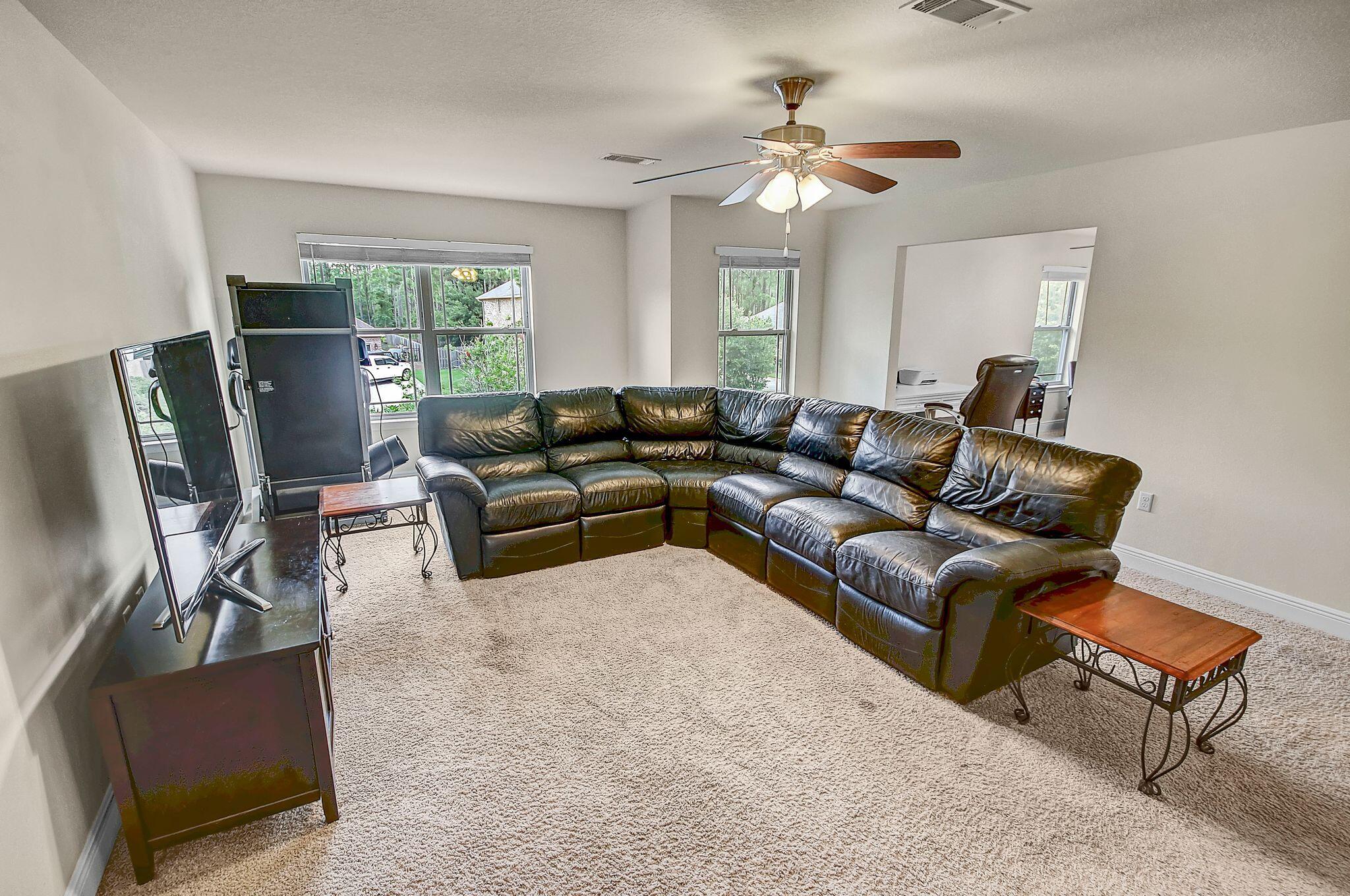 28 Haven Way Freeport, FL 32439 - Photo 22 of 50 a living room with furniture ceiling fan and a window