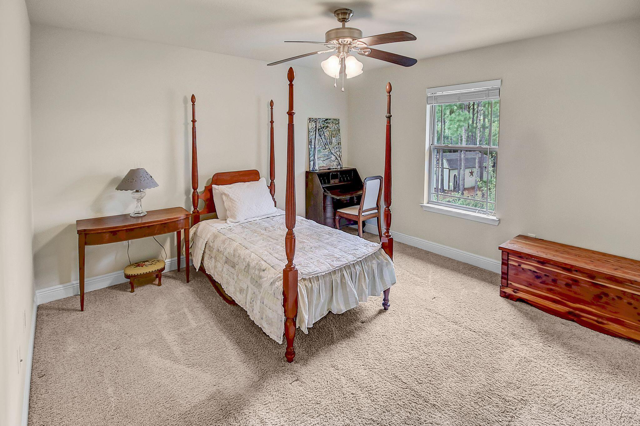 28 Haven Way Freeport, FL 32439 - Photo 25 of 50 a bedroom with a bed chandelier and a window