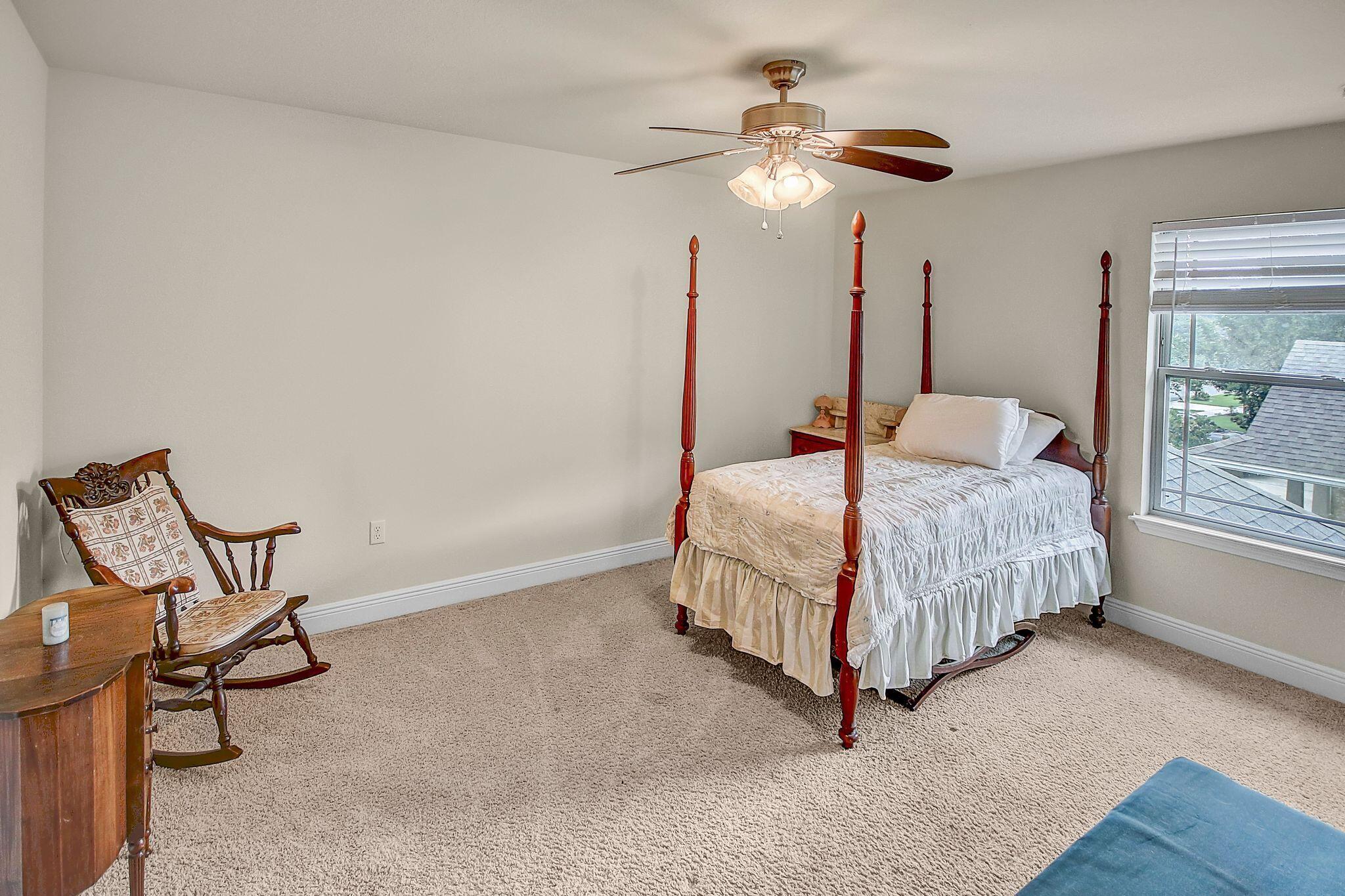 28 Haven Way Freeport, FL 32439 - Photo 26 of 50 a bedroom with a bed and a chandelier