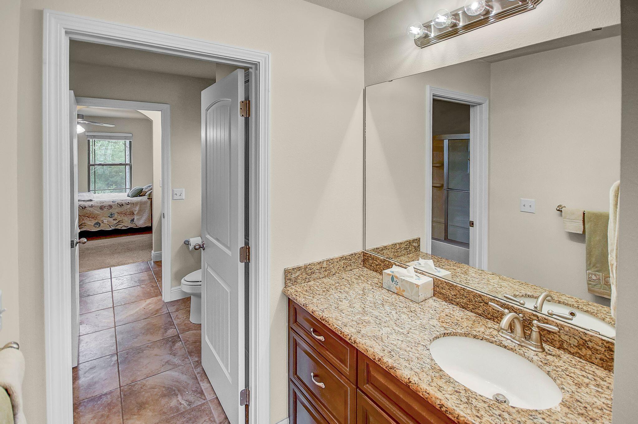 28 Haven Way Freeport, FL 32439 - Photo 28 of 50 a en suite bathroom with a granite countertop sink and a mirror