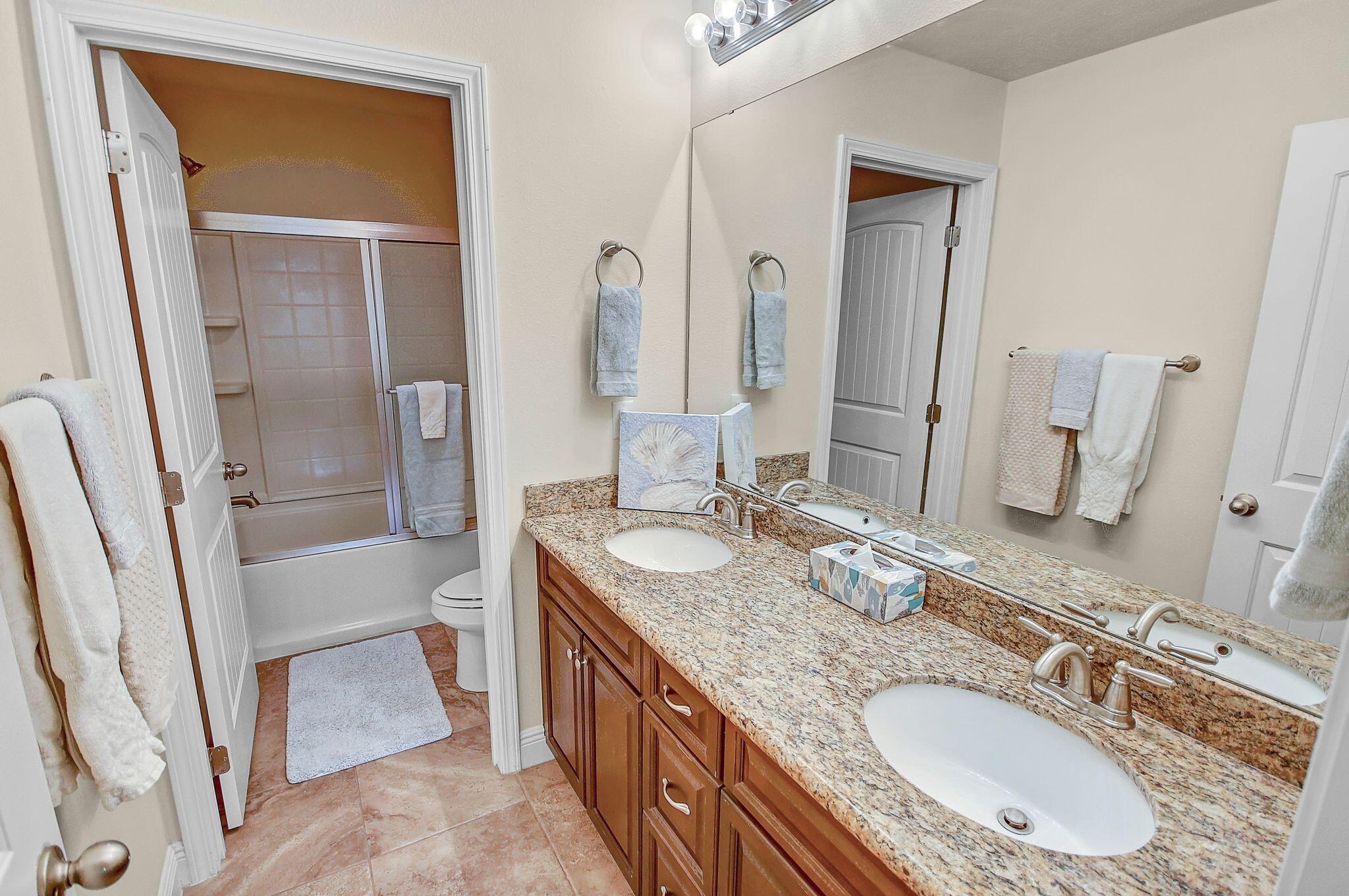 28 Haven Way Freeport, FL 32439 - Photo 29 of 50 a bathroom with a granite countertop tub sink and mirror