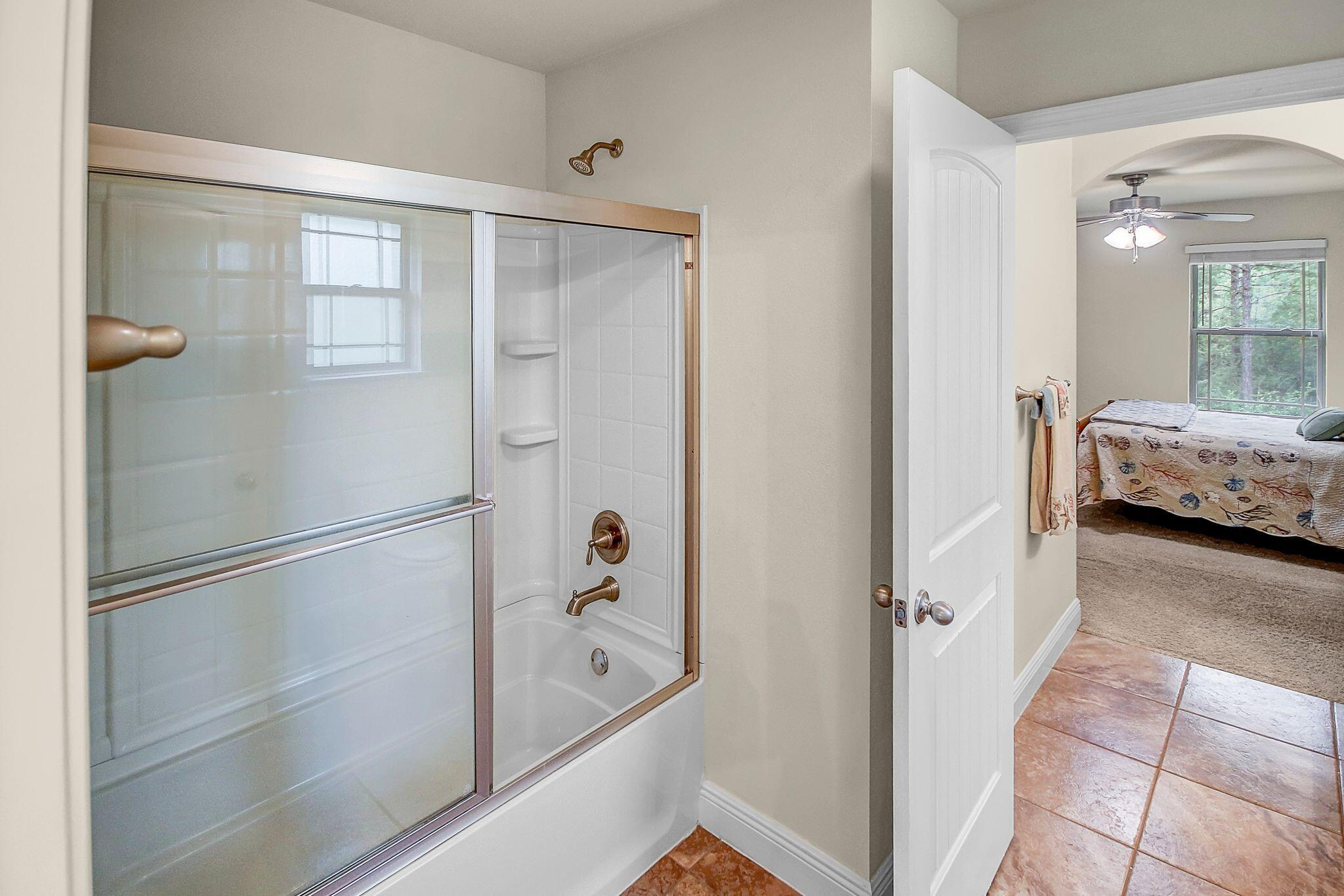 28 Haven Way Freeport, FL 32439 - Photo 30 of 50 a bathroom with a tub and shower