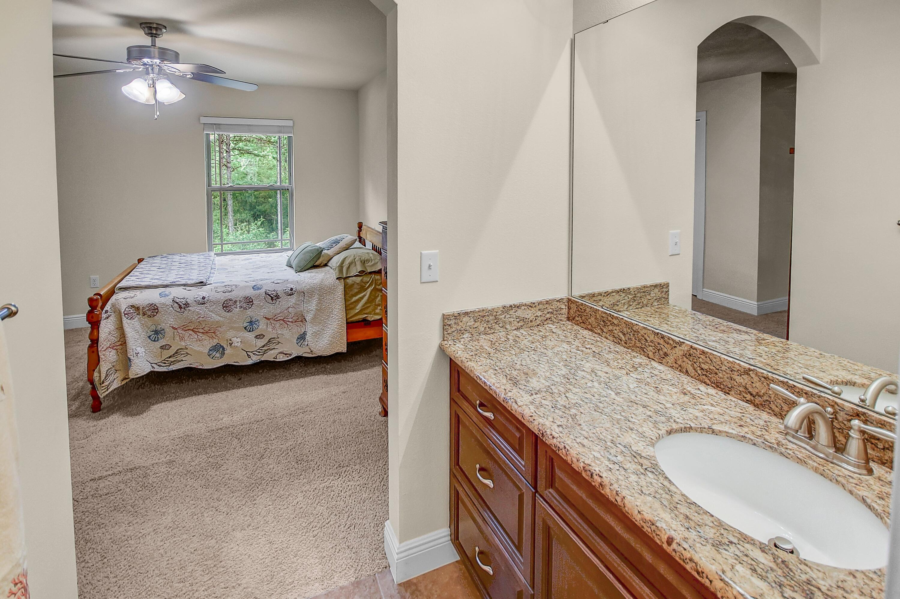 28 Haven Way Freeport, FL 32439 - Photo 31 of 50 a en suite bathroom with a granite countertop double vanity sink and a mirror