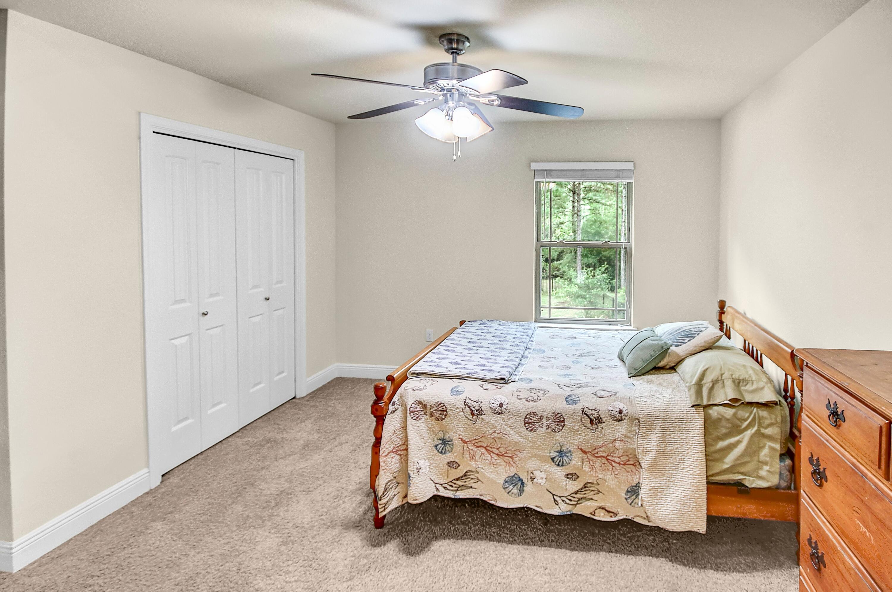 28 Haven Way Freeport, FL 32439 - Photo 32 of 50 a bedroom with a bed and a chandelier
