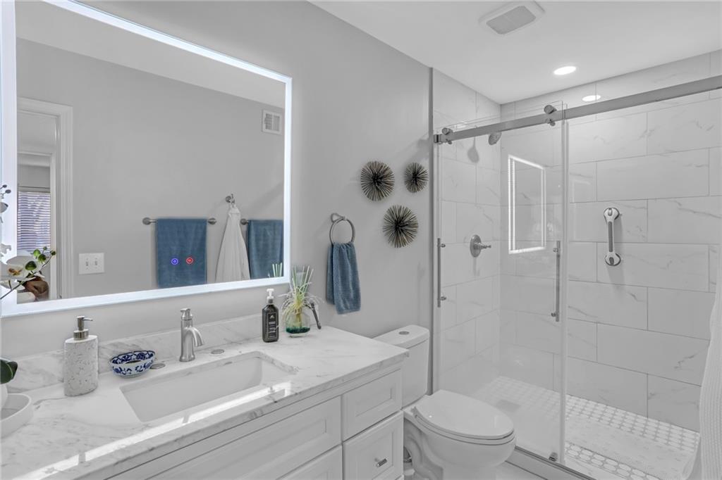 1211 Wingate Way Atlanta, GA 30350 - Photo 18 of 37 a bathroom with a sink a toilet and shower