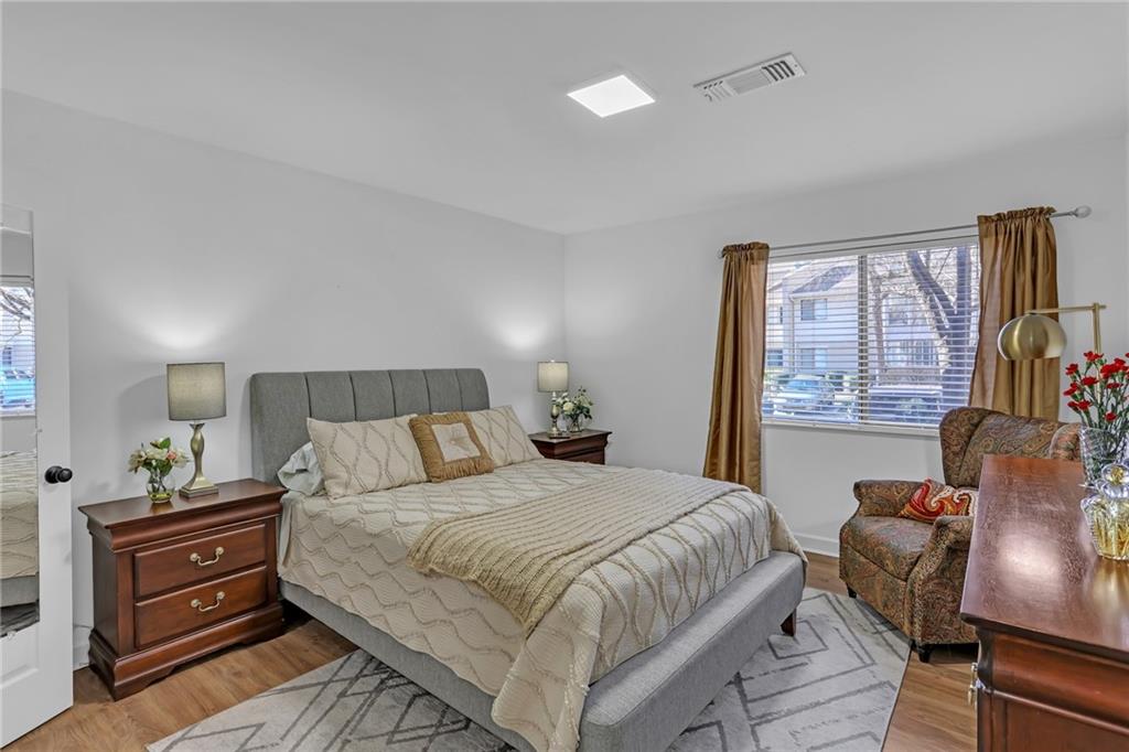 1211 Wingate Way Atlanta, GA 30350 - Photo 23 of 37 a bedroom with a bed and wooden floor