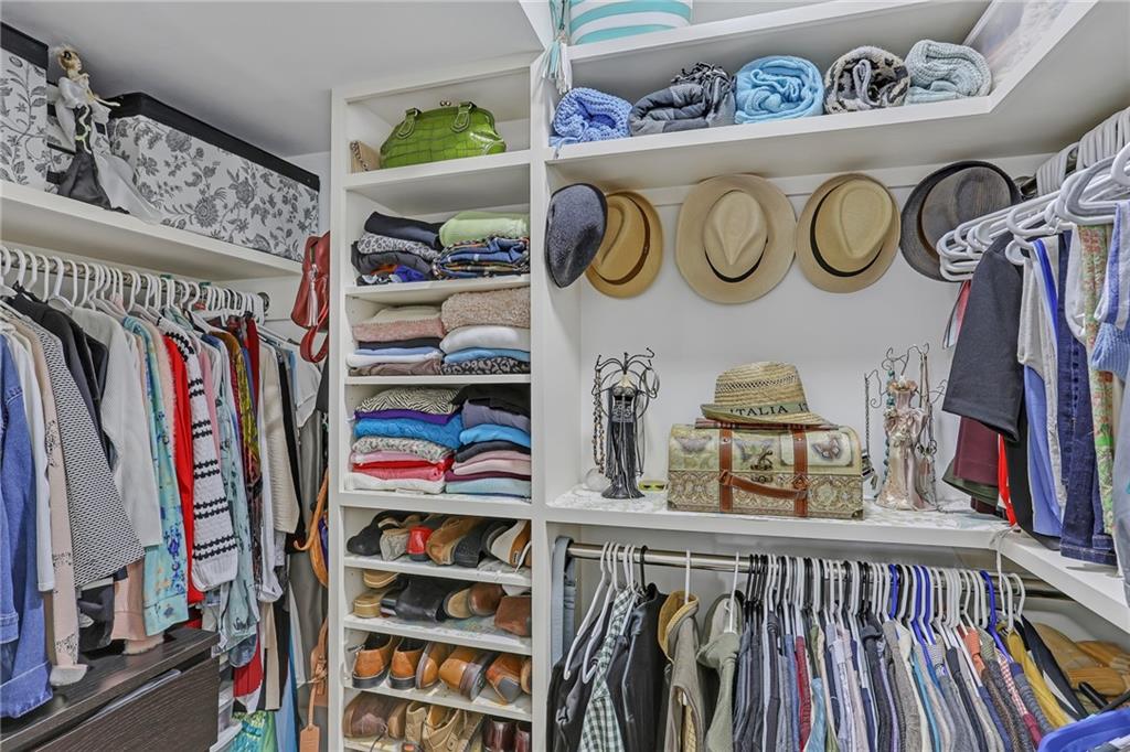 1211 Wingate Way Atlanta, GA 30350 - Photo 25 of 37 a view of walk in closet with clothes and shoes