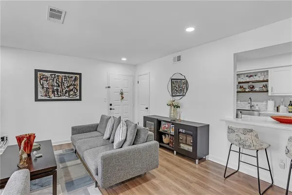 a living room with furniture and a wooden floor