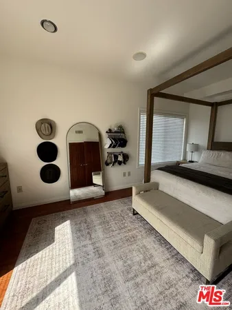 a living room with a couch and a dresser with mirror