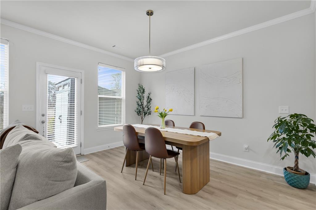 6710 Cedar Glen Road Atlanta, GA 30360 - Photo 11 of 35 a view of a dining room with furniture window and wooden floor