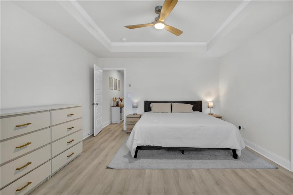 6710 Cedar Glen Road Atlanta, GA 30360 - Photo 19 of 35 a bedroom with a bed and a chandelier