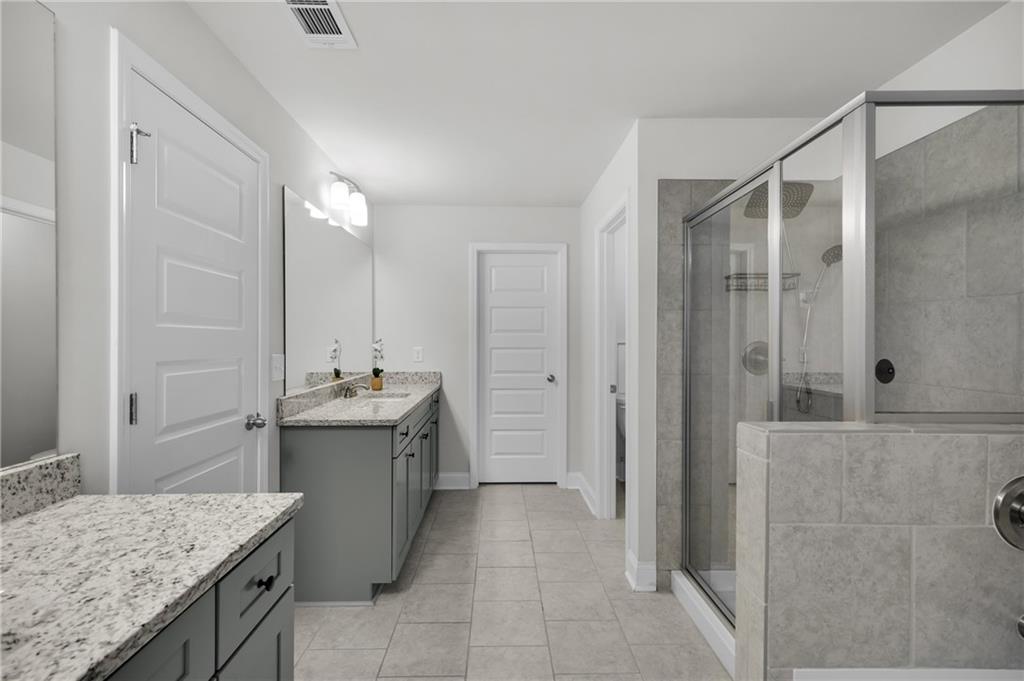 6710 Cedar Glen Road Atlanta, GA 30360 - Photo 23 of 35 a bathroom with a granite countertop sink a toilet and shower