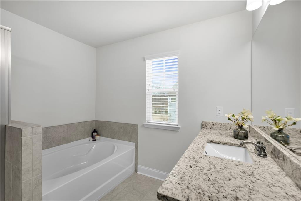 6710 Cedar Glen Road Atlanta, GA 30360 - Photo 25 of 35 a spacious bedroom with a bed and a window