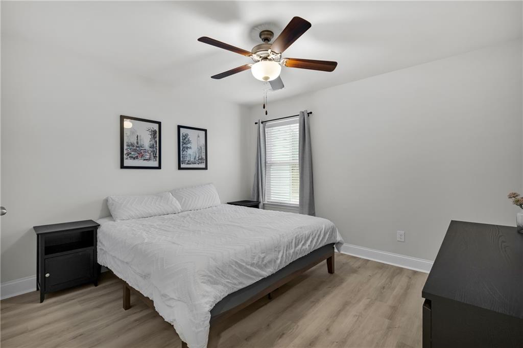 6710 Cedar Glen Road Atlanta, GA 30360 - Photo 28 of 35 a bedroom with a large bed and a ceiling fan