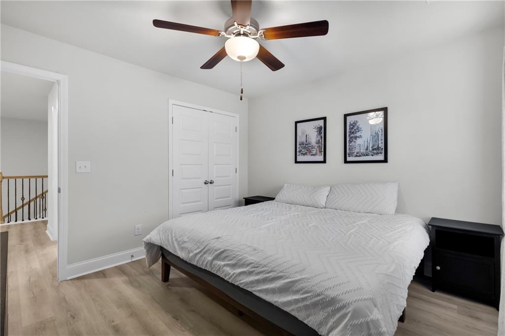 6710 Cedar Glen Road Atlanta, GA 30360 - Photo 29 of 35 a bedroom with a large bed and a chandelier