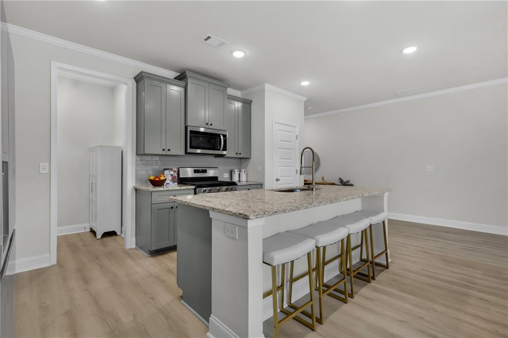 6710 Cedar Glen Road Atlanta, GA 30360 - Photo 5 of 35 a kitchen with stainless steel appliances granite countertop a sink a stove a refrigerator and a microwave