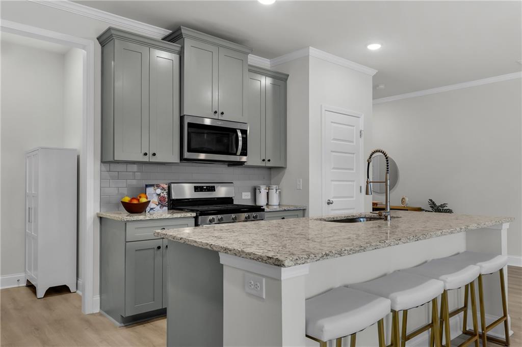 6710 Cedar Glen Road Atlanta, GA 30360 - Photo 6 of 35 a kitchen with sink a microwave and cabinets