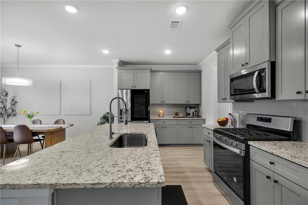 6710 Cedar Glen Road Atlanta, GA 30360 - Photo 7 of 35 a kitchen with stainless steel appliances granite countertop a sink stove and refrigerator