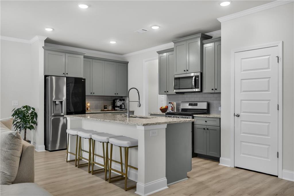 6710 Cedar Glen Road Atlanta, GA 30360 - Photo 9 of 35 a kitchen with appliances a counter space and cabinets