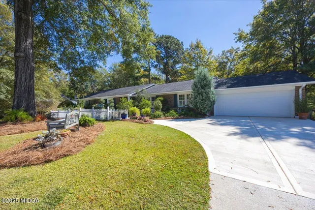a front view of a house with swimming pool and sitting area