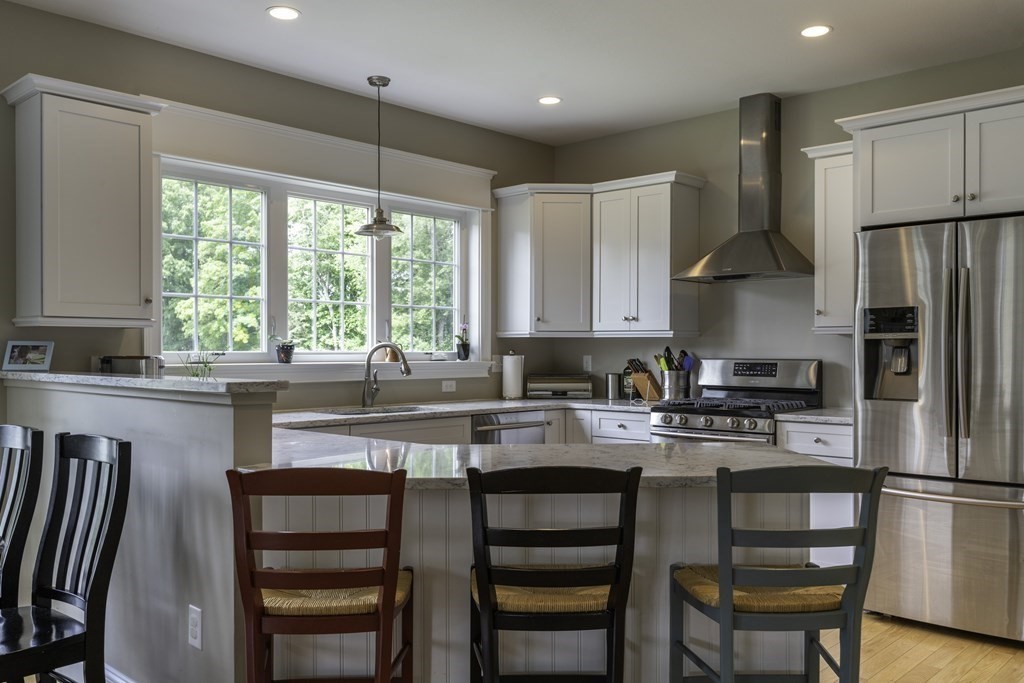 2 Chatham Way South Hadley, MA 01075 - Photo 13 of 40 a kitchen with a refrigerator a stove a sink and white cabinets with wooden floor