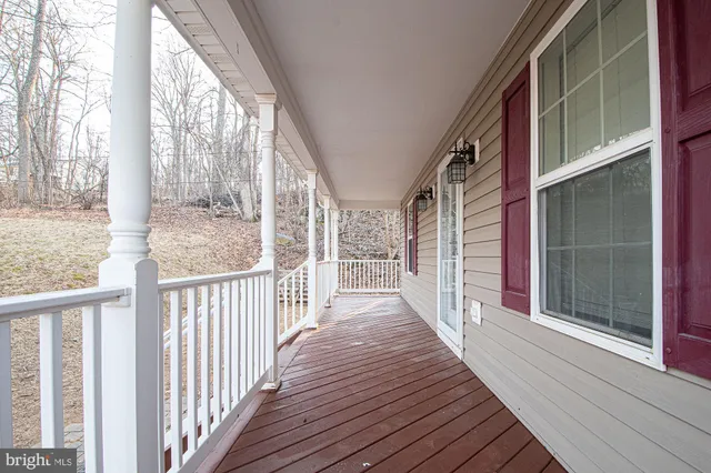 a view of a house with wooden floor next to a iron stairs