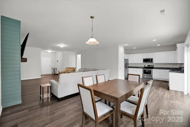 a dining room with furniture and wooden floor