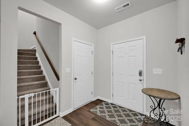 a view of an entryway with wooden floor