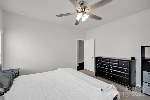 a bedroom with a bed and ceiling fan