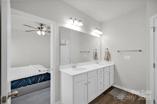 a spacious bathroom with a double vanity sink and a mirror