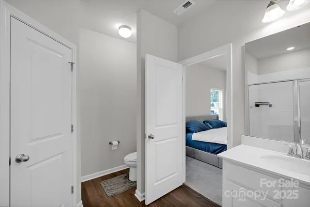 a bathroom with a tub shower vanity and a sink