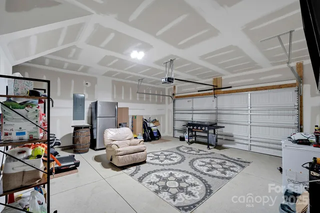 a living room with furniture a flat screen tv and a table