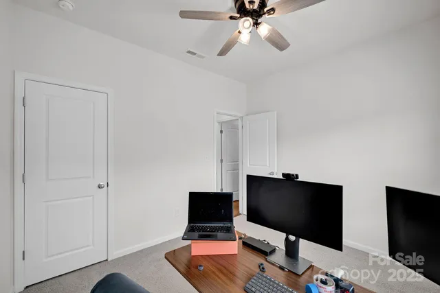 a desktop computer sitting on top of a desk and a computer on a desk next to a window
