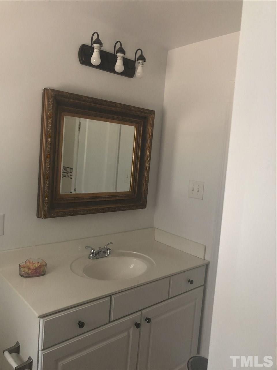 2900 Alron Road Wendell, NC 27591 - Photo 12 of 15 a bathroom with a sink and a mirror