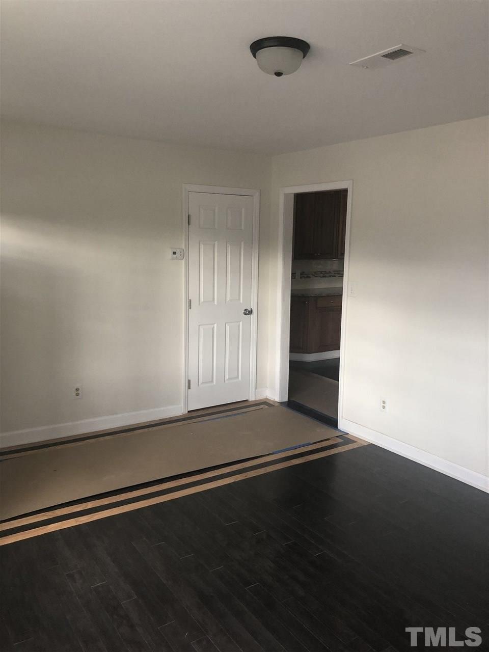 2900 Alron Road Wendell, NC 27591 - Photo 4 of 15 an empty room with wooden floor and windows